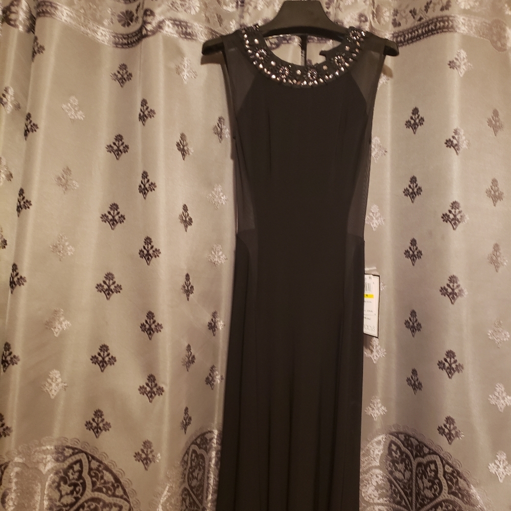 NWT. Beautiful Black Dress with Embellished Neckline. Fits 7/8